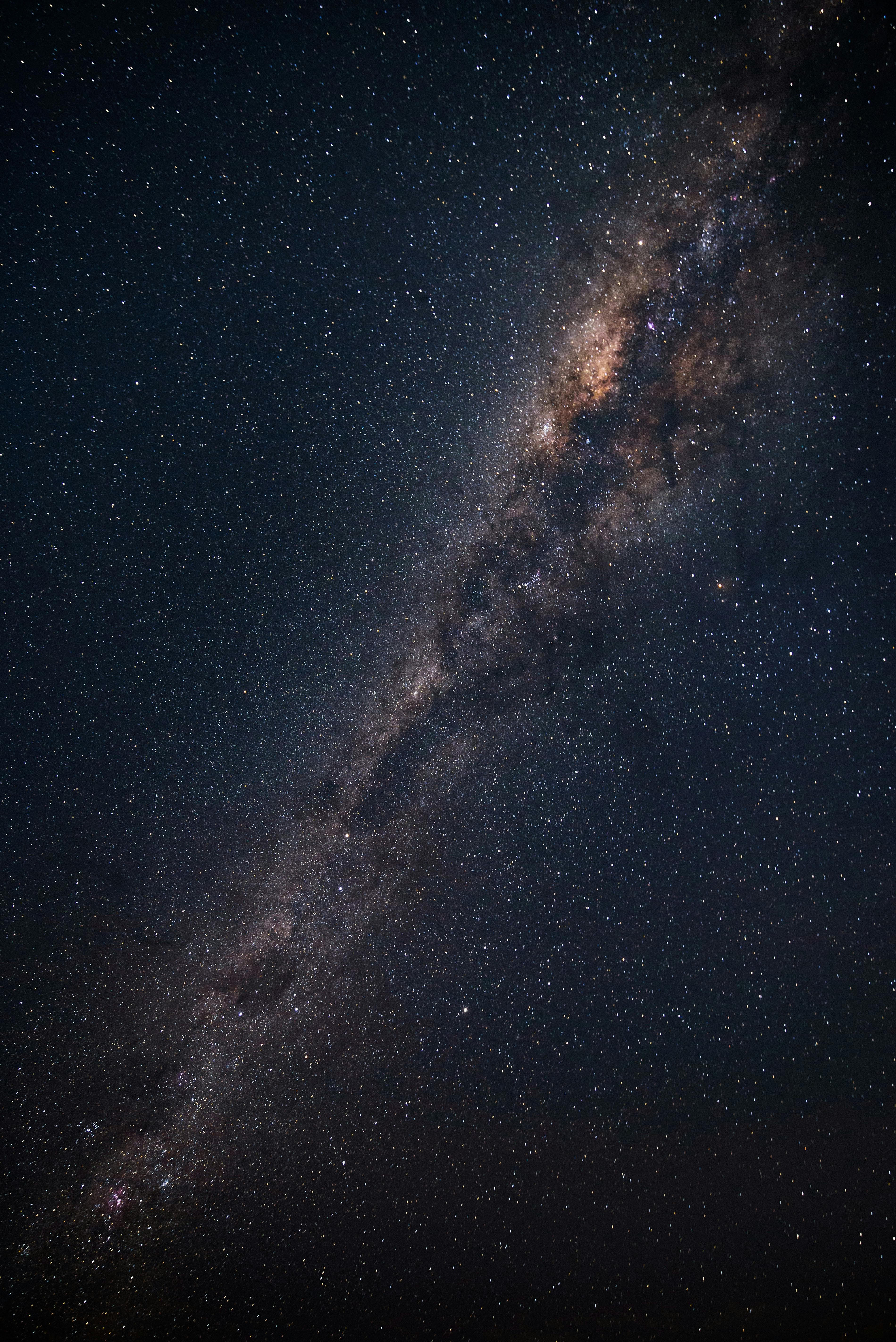 Explorer on a mountain ridge under the Milky Way.